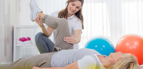 Certified Physical Therapist helping a patient