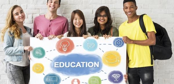 students holding a poster saying "Education"