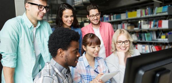 Students Standing Around Computer Working