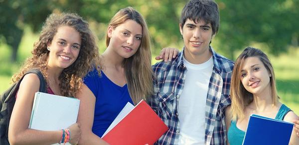 Four Students Standing Outside