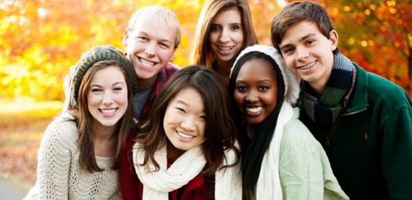 Group Of Students Outside With The Setting Sun In The Background