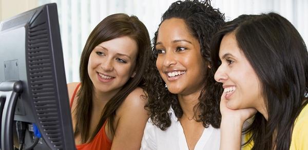 Three Students Sitting At Computer