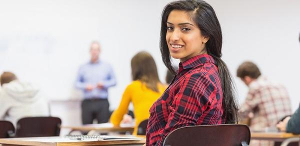 Student Looking Back As Teacher Lectures In Class