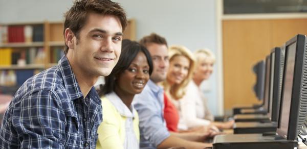 4 students in a computer lab working on computers