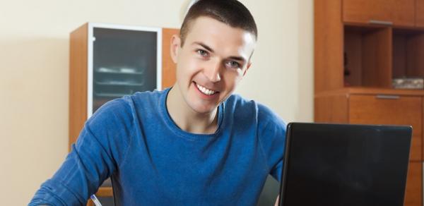 Smiling Student with a Laptop
