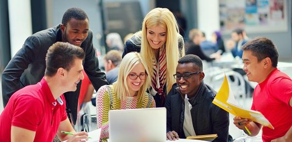 Students Sitting In Cafeteria Working