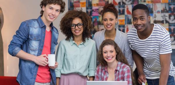 Students Posing Around A Laptop