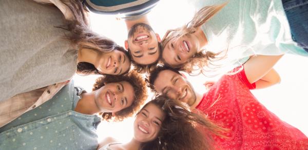 Students In A Circle Looking Down At Camera