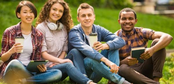 group of students sitting on lawn