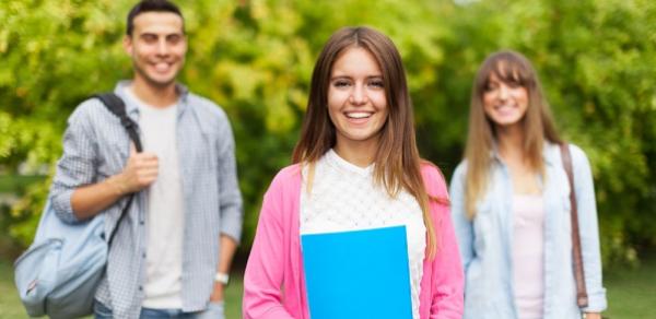 Three Students Standing Outside With Books