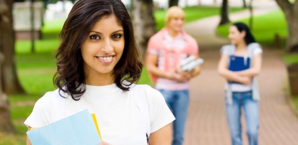 Three Students Walking On A Brick Path Outside