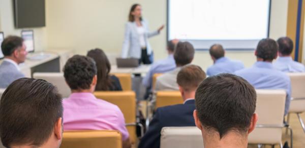 Teacher Showing A Presentation As Class Looks On