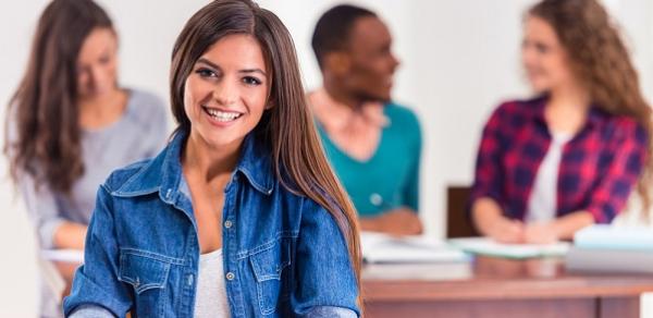 Students Seated At Desk Working In Class