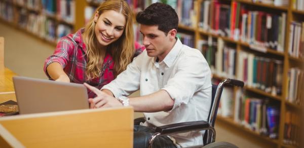 man in wheelchair in library