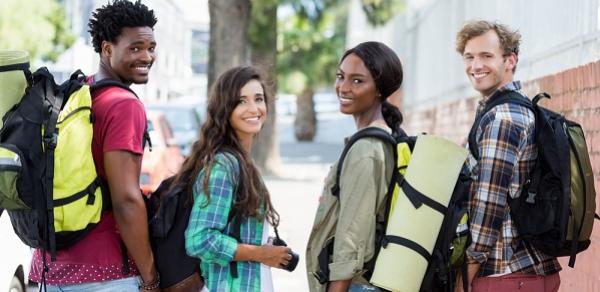 Four Students Walking Outside Turned Around