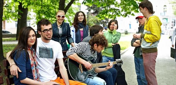 Students Sitting Under A Tree On A Bench