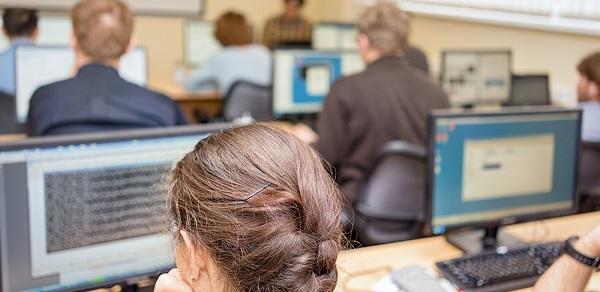 Students In Class Together On Computer