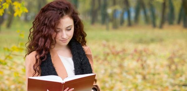 Student Reading A Book Outside