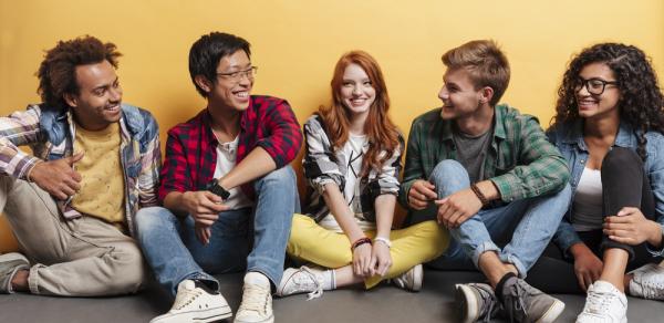 Students sitting against wall