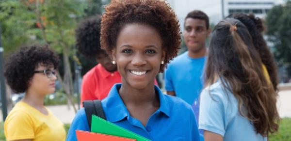 Smiling Student Holding Books