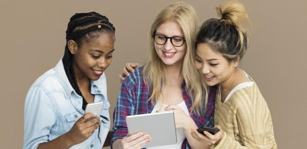 Three Students Holding Different Devices