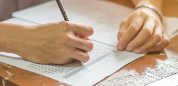 student filling in bubbles on test