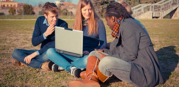 Students Outside Looking at Computer