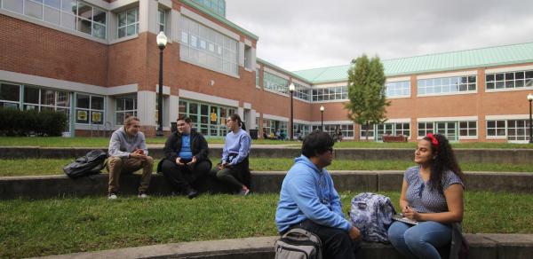 CSI Students sitting outside Building 1P in the ampitheater