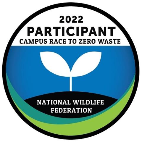 2022 Campus Race to Zero Waste Participant round logo with two white leaves with the blue background. 