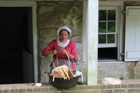 A woman holding a basket in Historic Richmond Town