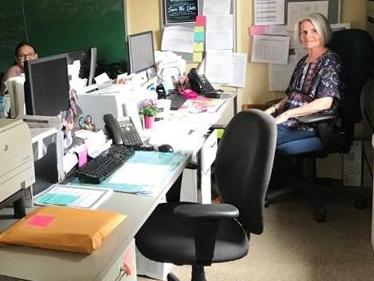 Office of Continuing Education staff supporting CSI's Daylight Hour social media campaign by shutting of the light in their office as they sit my their desk. ​