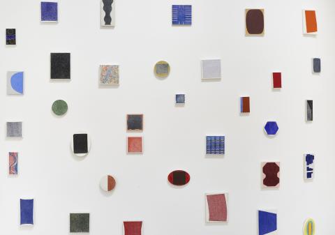 wall arrange of small abstract paintings