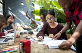 people at table reviewing papers