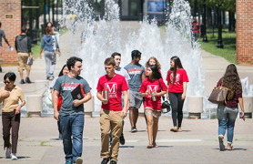 Honors students walking past CSI fountain