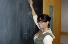 Teacher writing on chalkboard