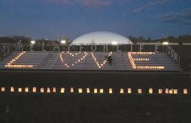 CSI bleachers with candles lit to spell LOVE