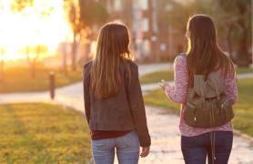 Two Students Walking In The Setting Sunlight