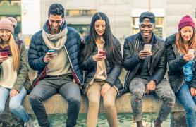 Students engaged with their smartphones on campus