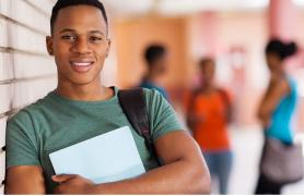 Student Leaning On Wall With Books