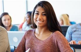 Student Smiling At Desk