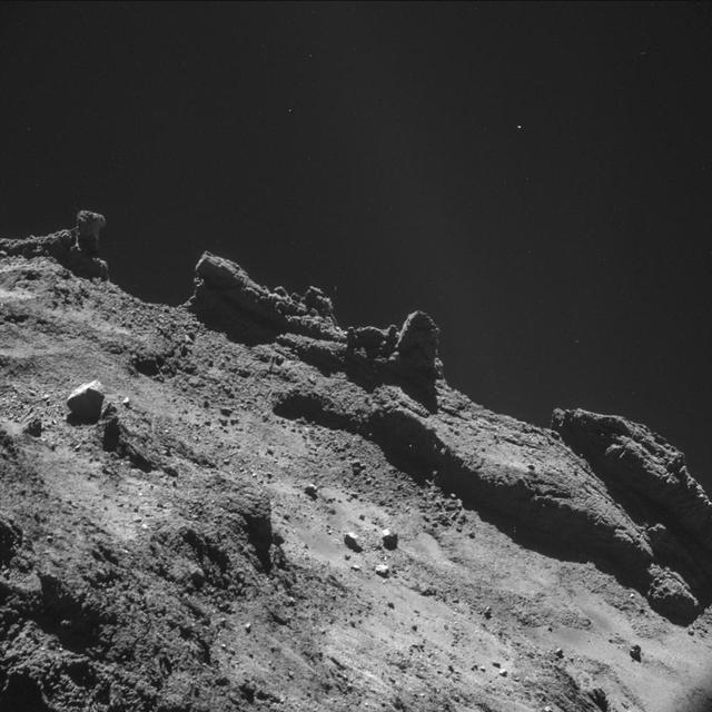 ICEY/ROCKY SURFACE OF A COMET FROM CLOSE UP IN SPACE 